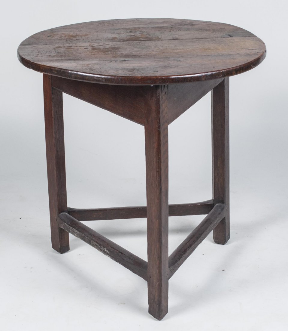 Tavern Table: Circular top on three block legs, joined by a conforming stretcher. Height 27 inches, diameter 26 inches. Provenance: Warren Means Trust Notice to bidders: Condition reports and additional photographs