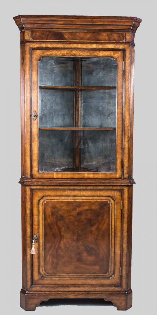 Mahogany Corner Cabinet: Molded cornice over a single glazed door opening to a mirrored interior with two glass shelves, above a single door cabinet, bracket feet. Height 7 feet, width 34 inches, depth 21 inches. Notice to bi