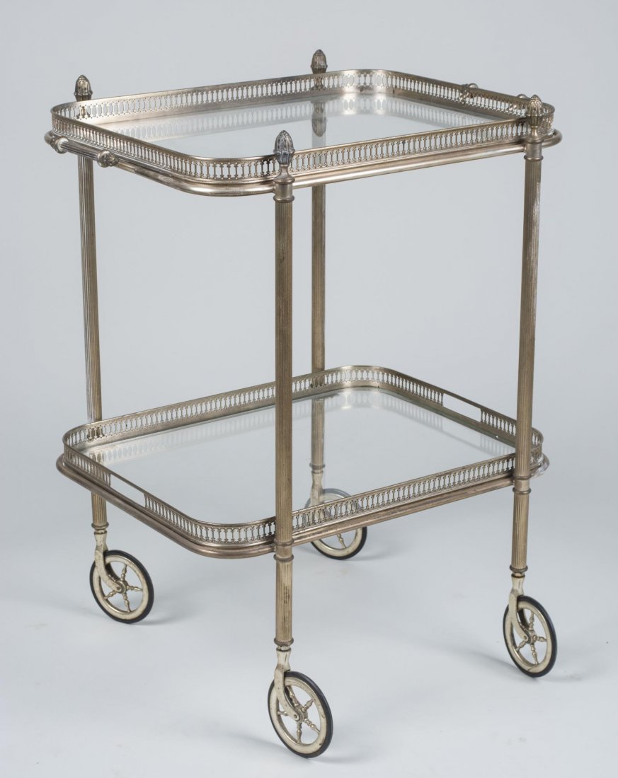 Brass and Glass Tea Cart: Two glass shelves with brass gallery. Height 30 inches, width 26 inches, depth 19 inches. Notice to bidders: Condition reports and additional photographs are provided by request as a courtesy to our c