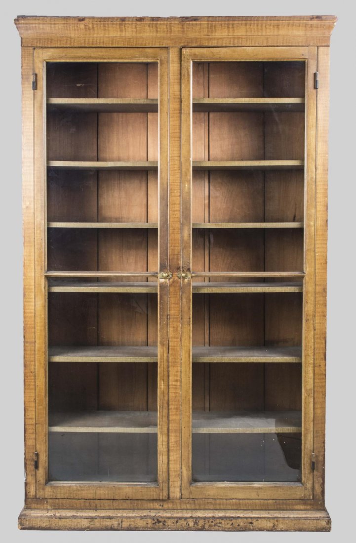 Vitrine Cabinet: Rectangular molded cornice above two glazed doors opening to seven shelves, plinth base. Height 6 feet 9 inches, width 49 inches, depth 12 inches. Provenance: Warren Means Trust Notice to bidders: Con
