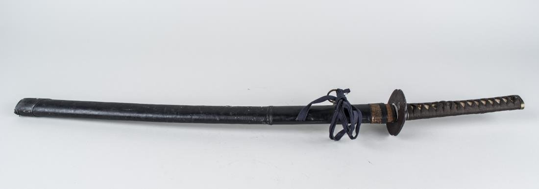 Japanese WWII Era Katana *: The single edge curved blade with single fuller, bronze tsuba with flying bird decoration, cord wrapped shagreen grip, bronze pommel, and black leather scabbard, signed on tang. Blade length 27 inches