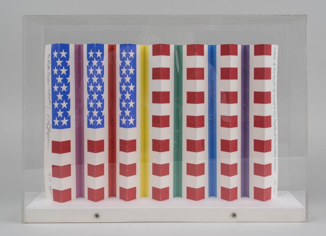 Yaacov Agam (Israeli, b.1928): Reversible American Flag and Star of David. Folded serigraph on paper, 1985. Signed, dated and inscribed on the edge. Height 9 inches, width 13 inches, depth 1 inch. Incased in acrylic box. Notice to 