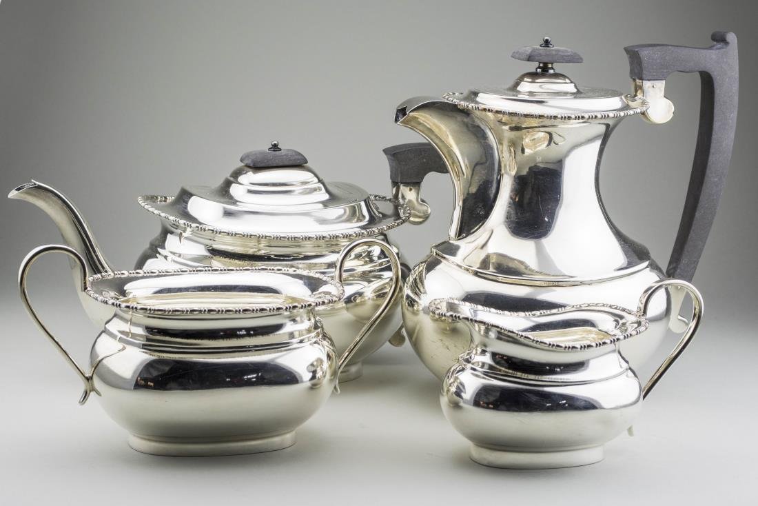 English Silver Coffee and Tea Service: Sheffield, 1948, makers mark EV, comprising a coffee pot, teapot, milk jug and sugar bowl. Coffee pot, height over handle, 8 1/2 inches, inches, total 2000 grams, all inclusive. Notice to bidders: Con