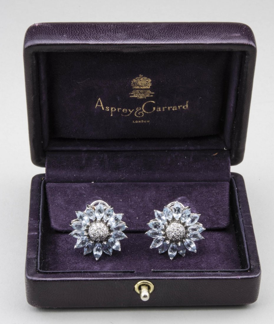 Asprey Blue Topaz & Diamond Daisy Flower Earrings: 18k white gold, each earring set with fourteen blue topaz petals centering a diamond cluster. Notice to bidders: Condition reports and additional photographs are provided by request as a courtesy to o