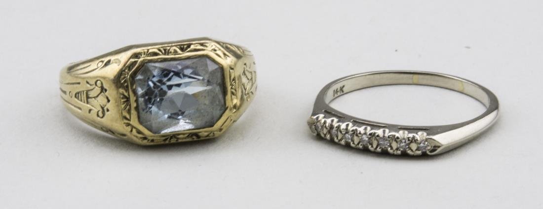 Two Gold Rings: One, 14k white gold band with seven round diamonds size 8; and a 14k yellow gold ring with a faceted blue topaz, size 8. Total 12.5 grams, all inclusive. Provenance: Ralph and Fanny Ellison Charitable