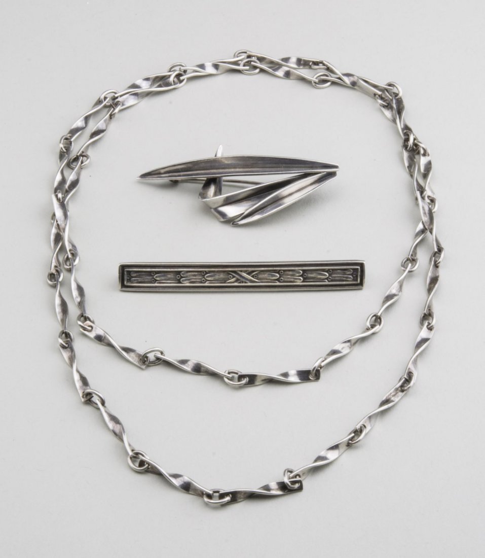 Three Sterling Silver Jewelry Articles: A Georg Jensen twisted bar chain necklace, length 28 inches, a Danish pin signed AM for A. Michelsen, 2 inches x 3/4 inch; and an R. Blackington & Co. bar pin, length 2 3/8 inches. Notice to bidders: