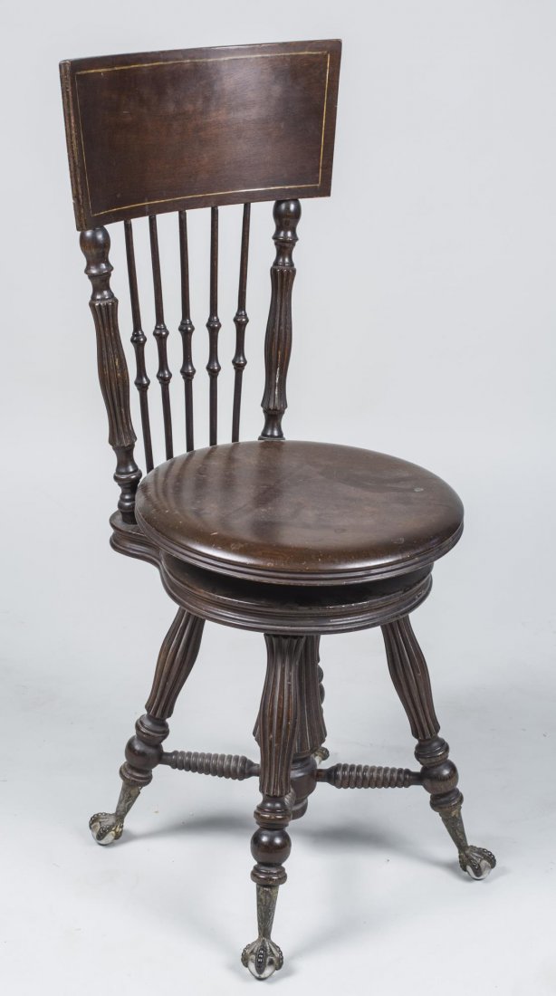 Mahogany Piano Chair: Late 19th century, tablet crest rail on spindle chair chair with revolving adjustable seat, turned legs ending in claw and glass ball feet. Height 37 inches, width 16 inches, depth 17 inches. Provenan