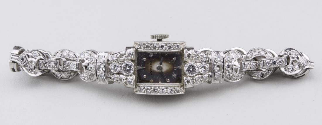 Hamilton Lady's Diamond Watch: 14k white gold, watch case and band set with round diamonds. Length 6 1/2 inches. Notice to bidders: Condition reports and additional photographs are provided by request as a courtesy to our clients,