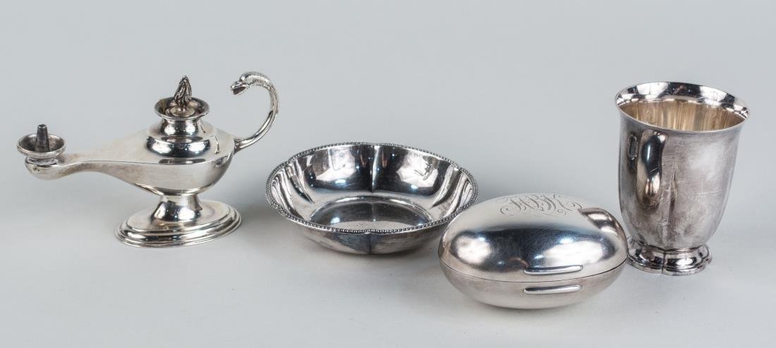 Four Silver Articles: Including a Continental 800 silver tumbler and a small circular dish, English silver oil lamp and a Gorham silver plated egg form box, monogrammed. Tumbler height 3 inches. Notice to bidders: Conditio