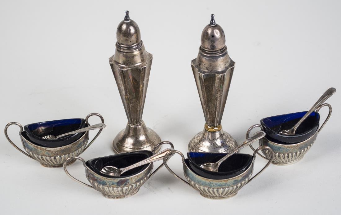 Group of Sterling and Silver Plated Table Articles: Comprising a pair of sterling silver shakers and a set of four silver plated salt cellars with cobalt glass liners and four spoons. Shaker height 5 1/2 inches. Notice to bidders: Condition reports and