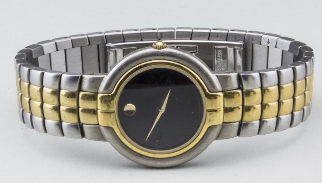 Movado Lady's Watch: Black dial without hours, gold tone and stainless steel band. Notice to bidders: Condition reports and additional photographs are provided by request as a courtesy to our clients, as such any conditio