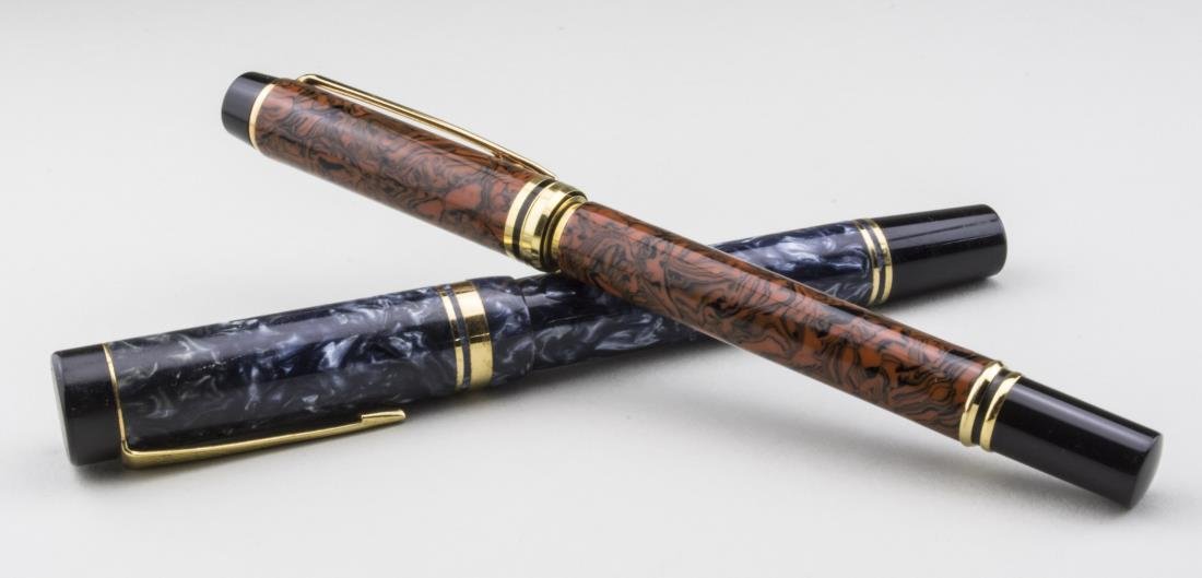 Waterman & Parker Fountain Pens: Waterman red case with gold tone trim and clip, marked 'Made in France', 18k gold nib, length 5 1/2 inches; together with a Parker blue case with gold tone trim and clip, 18k gold nib, length 5 1/4 in