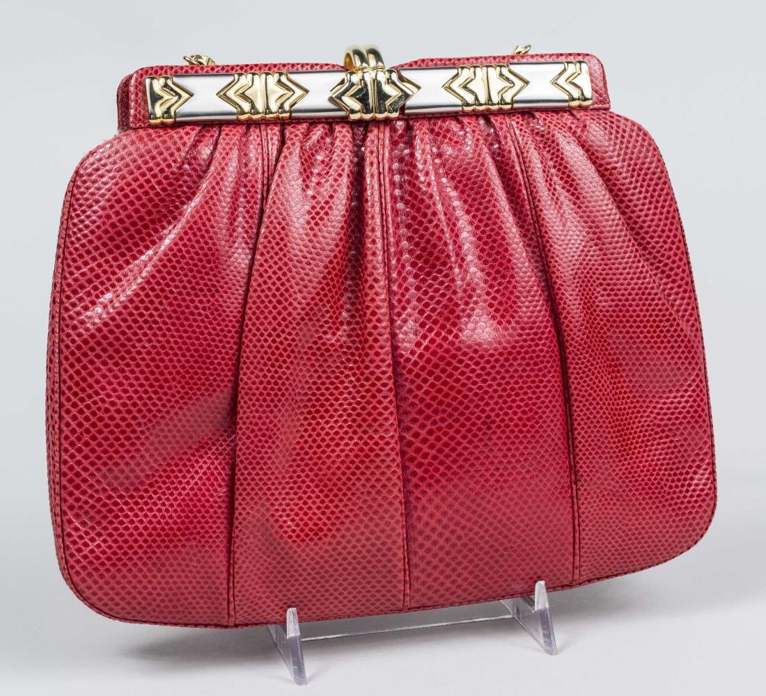 Judith Leiber Purse: Red reptile skin with gold tone clasp. 7 x 9 inches. Notice to bidders: Condition reports and additional photographs are provided by request as a courtesy to our clients, as such any condition report
