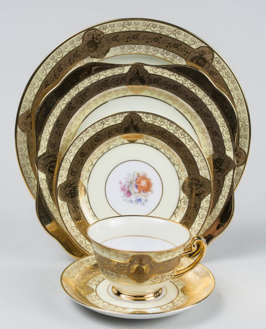 Limoge Porcelain Dinner Service: Comprising twelve dinner plates, eleven salad plates, twelve bread plates, eleven bowls, twelve fruit bowls, ten cups, twelve saucers, eleven demitasse cups, eleven demitasse saucers, creamer, covered