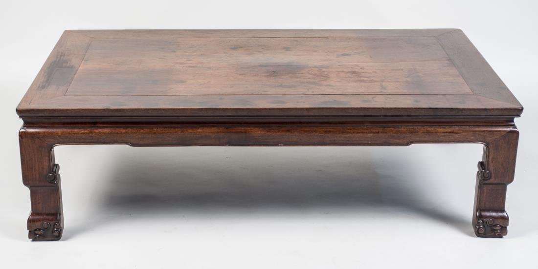 Asian Style Coffee Table: Rectangular top with crossbanded edge on Asian style block legs. Height 14 inches, width 47 inches, depth 29 inches. Notice to bidders: Condition reports and additional photographs are provided by req