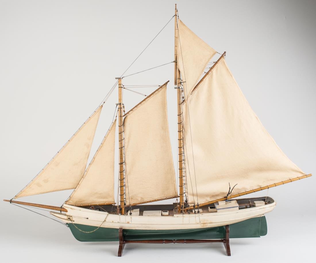 Model of a Schooner: Modelled in full sail. Height 23 inches, Notice to bidders: Condition reports and additional photographs are provided by request as a courtesy to our clients, as such any condition report is only an o