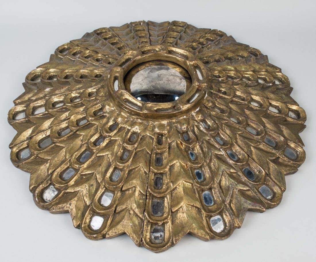 Gilt Wood Starburst Mirror: Circular convex mirror plate radiating loops and arrow decoration. Diameter 22 inches. Notice to bidders: Condition reports and additional photographs are provided by request as a courtesy to our clie