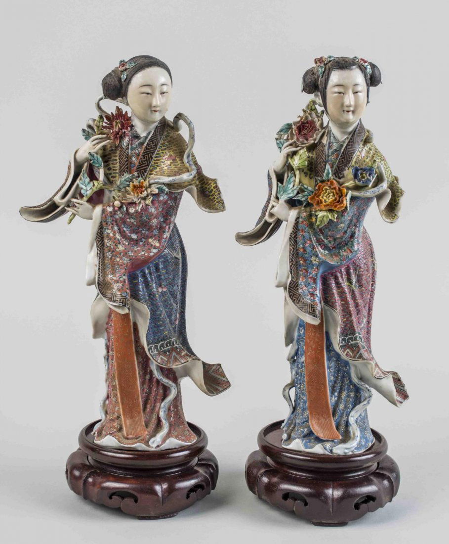 Pair of Chinese Porcelain Maiden Figures: Each modeled standing in long flowing robes, on a carved wood base. Height 11 1/2 inches. Notice to bidders: Condition reports and additional photographs are provided by request as a courtesy to our c
