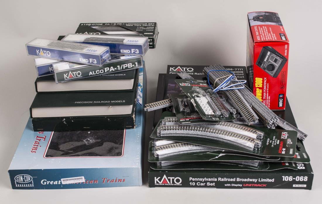 Group of KATO N-Scale Model Trains: Comprising five boxed sets of Pennsylvania Railroad and New York Central Lines cars and locomotives, seven individual locomotives and passenger car, and a group of track; together with a MRC model tra