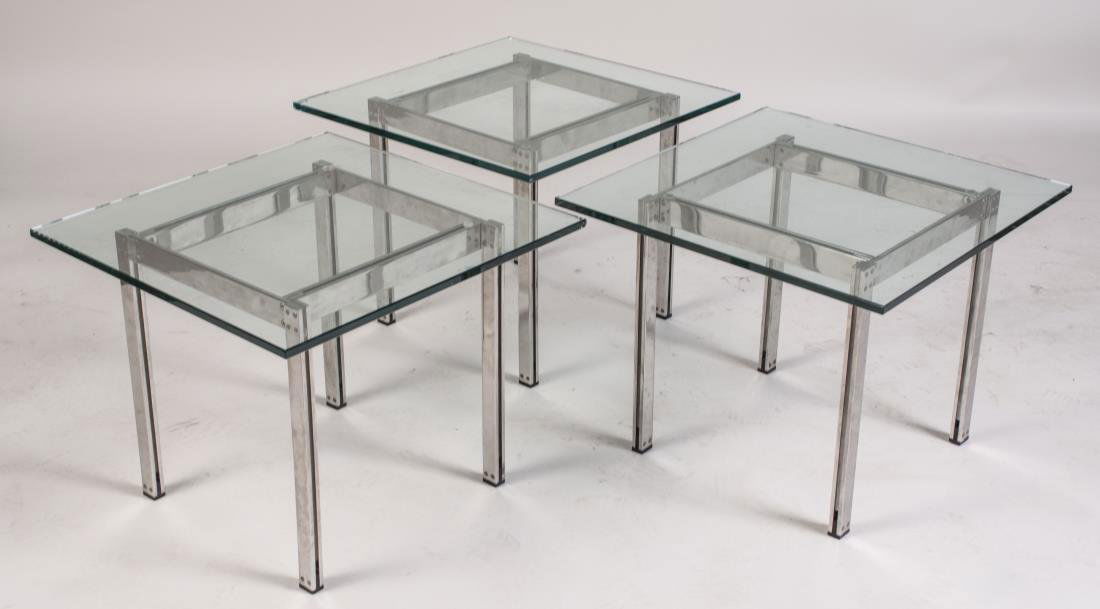 Set of Three Glass Top Low Tables: Each with a square glass top on a chrome base. Height 16 inches, 20 inches square. Notice to bidders: Condition reports and additional photographs are provided by request as a courtesy to our clients,