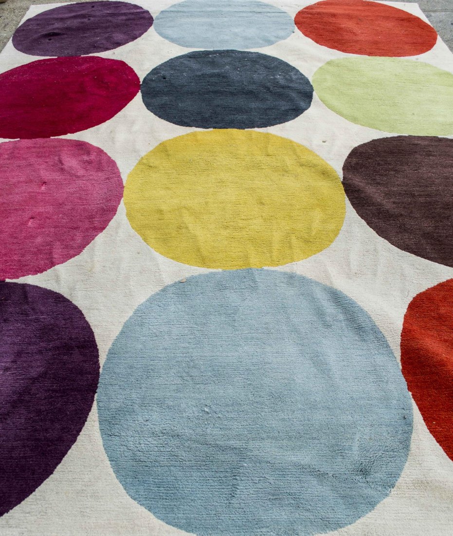 Susanne Sharp Smarties Rug: By the Rug Company, part of The Contemporary Collection, four rows of three colored circles on an ivory field. 12 feet 2 inches x 9 feet. Notice to bidders: Condition reports and additional photograph