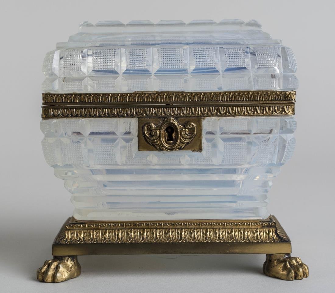 French Opaline Glass Dresser Box: Gilt bronze mounted moulded and cut glass box, with acanthus leaf border decoration, on animal paw feet. Height 5 3/4 inches. Notice to bidders: Condition reports and additional photographs are provid