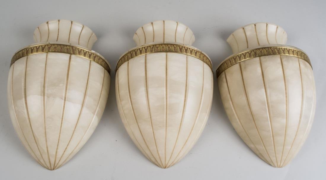 Set of Three Alabaster Wall Sconces: Vase form sconces, with a leaf border decoration. Height 12 inches. Notice to bidders: Condition reports and additional photographs are provided by request as a courtesy to our clients, as such any co