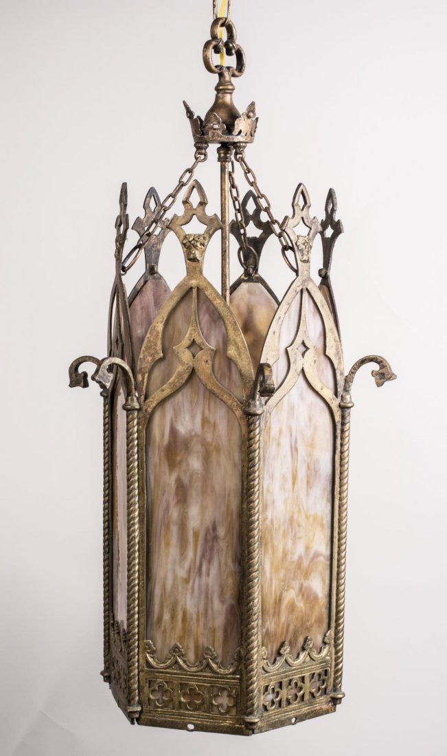 Gothic Style Hanging Light: Patinated metal light with slag glass panels. Height 32 inches, width 16 inches. Notice to bidders: Condition reports and additional photographs are provided by request as a courtesy to our clients, a