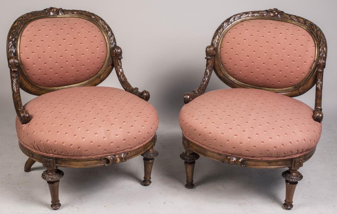 Pair of Bronze Trim Slipper Chairs: Neoclassical style, each with oval back within a laurel leaf carved crest rail with bronze collar, a bow front seat and toupie feet. Height 29 inches, width 25 inches, depth 29 inches. Notice to bidde