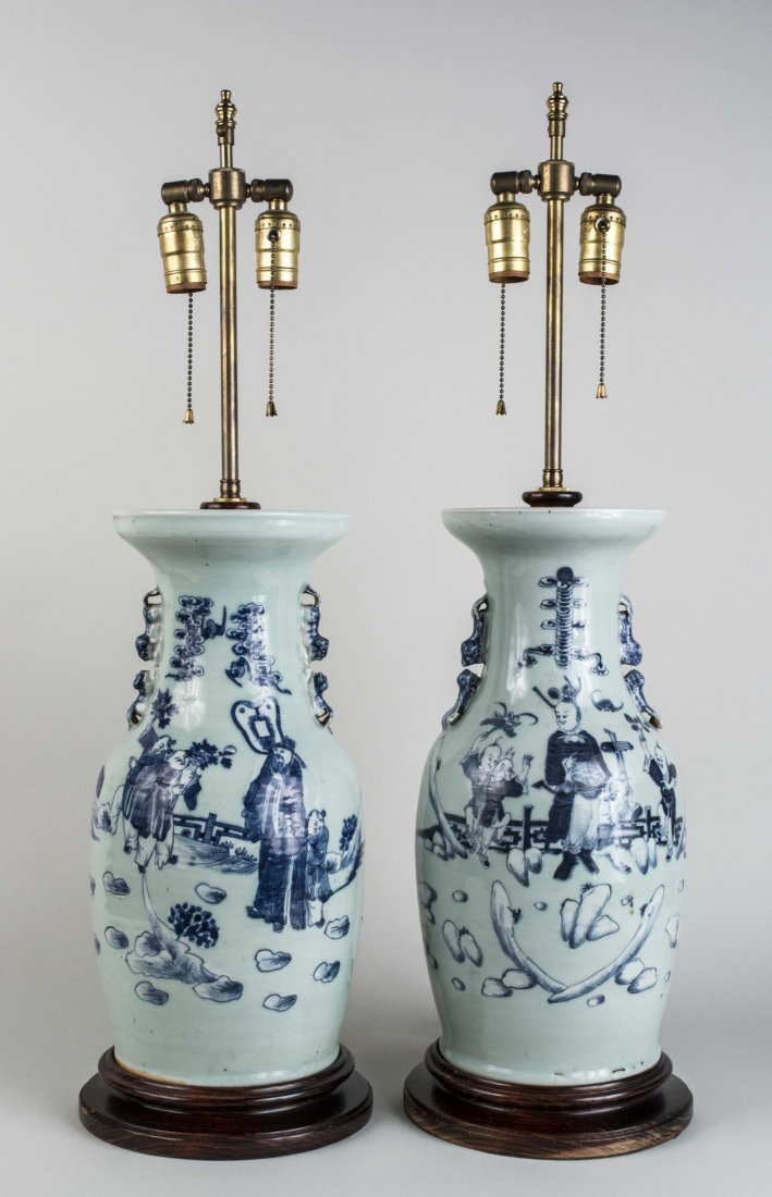 Pair of Chinese Porcelain Vase / Lamps: Two light lamps with blue and white decoration of figures in clouds. Base, height 18 1/2 inches. Notice to bidders: Condition reports and additional photographs are provided by request as a courtesy t