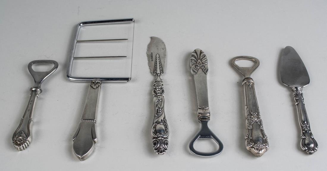 Group of Sterling Handled Flatware Articles: English silver master butter knife, a cake divider, three bottle openers and a cheese knife. Notice to bidders: Condition reports and additional photographs are provided by request as a courtesy to ou