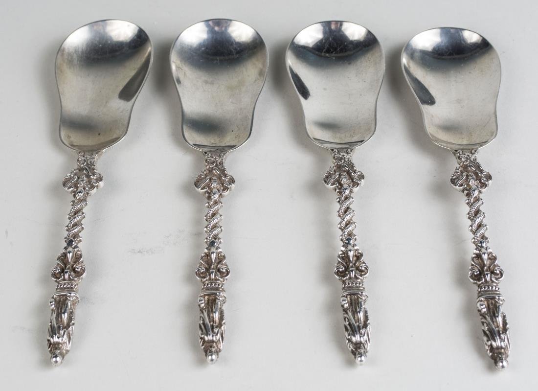 Set of Four English Apostle Style Spoons: London, 1897, maker's mark illegible, twisted scroll handle with figural terminus, violin shaped bowl. Length 8 inches, total 286 grams. Notice to bidders: Condition reports and additional photographs