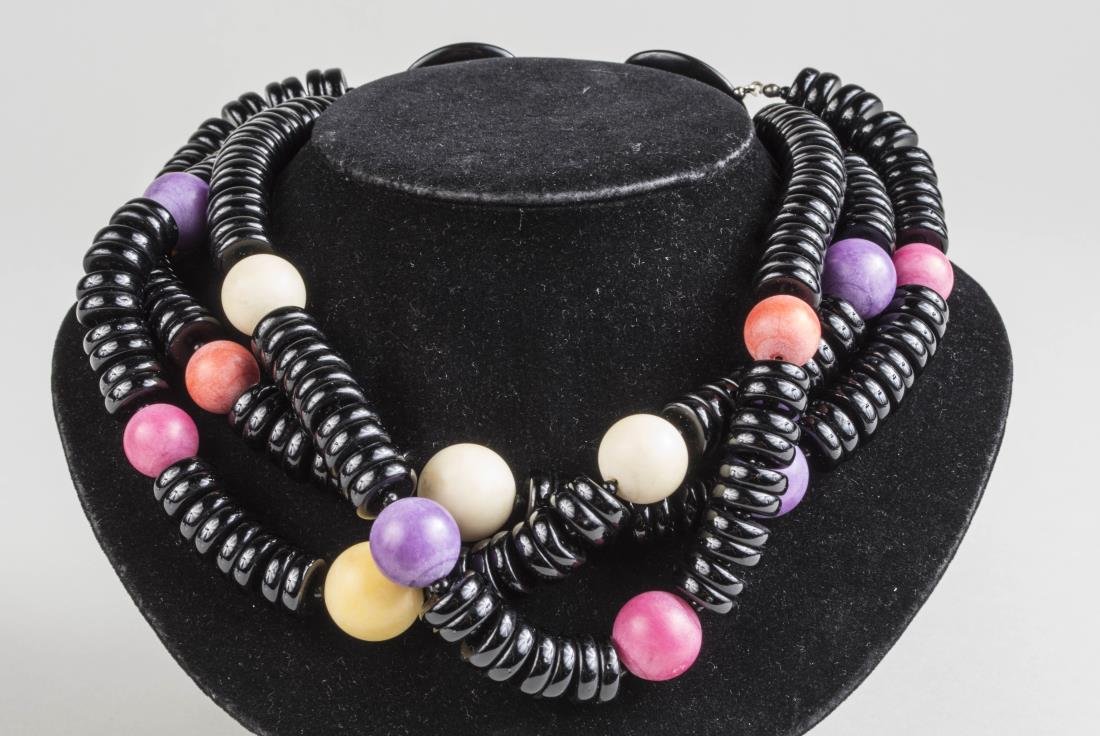 Miriam Haskell Necklace: Triple strand of black donut beads accented with colored beads. Length 16 inches. Notice to bidders: Condition reports and additional photographs are provided by request as a courtesy to our clients, 