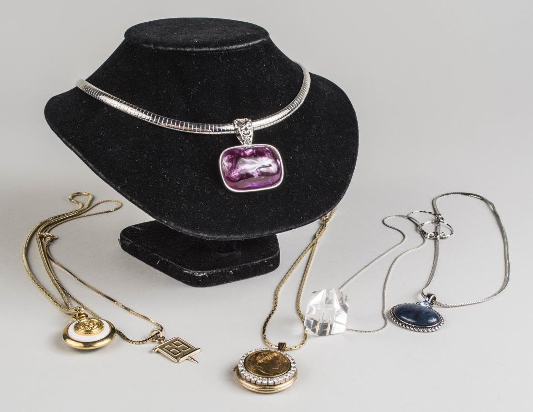 Six Pendant Necklaces: Including an omega silver tone necklace, signed 'lia sophia' another with '69' pendant, coin pendant, etc. Notice to bidders: Condition reports and additional photographs are provided by request as a 