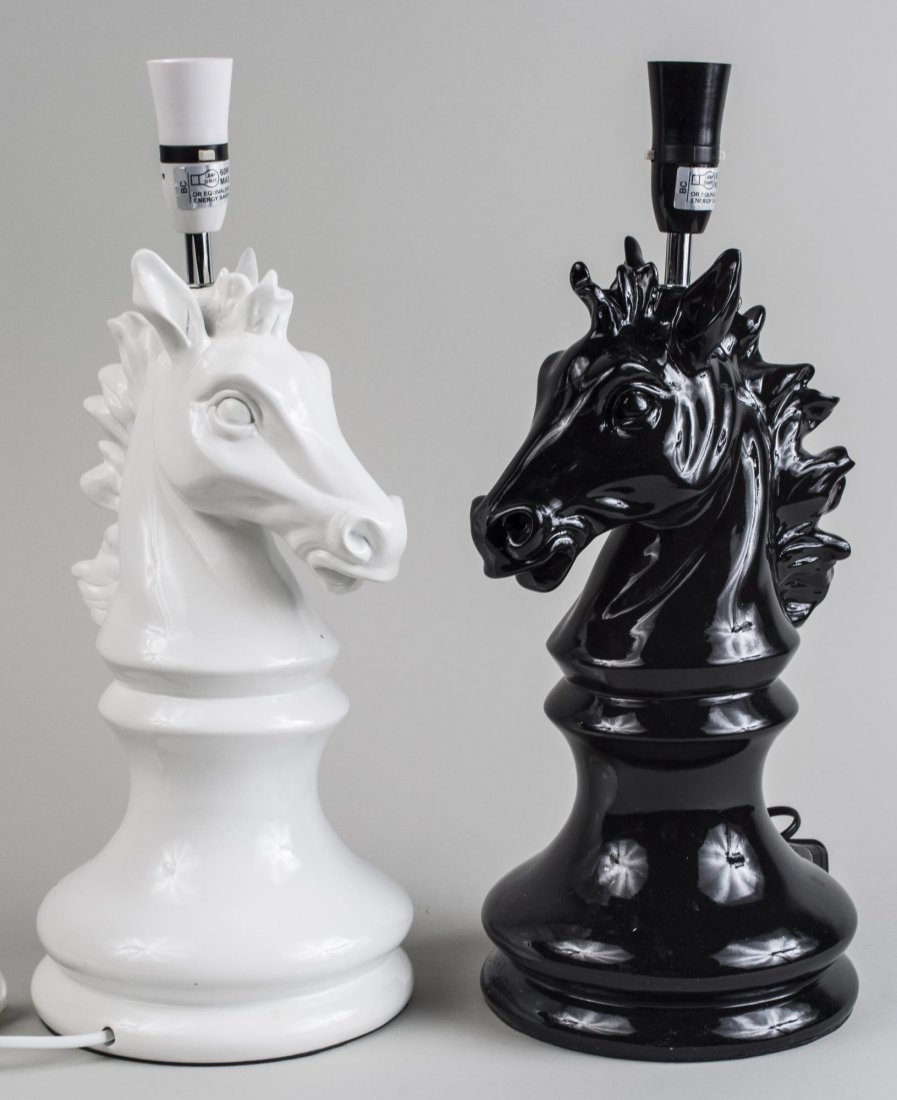 Pair of Horse Head Lamps: Single light lamps designed as Knight Chess pieces, one black and one white. Overall height 18 1/2 inches. Notice to bidders: Condition reports and additional photographs are provided by request as a 