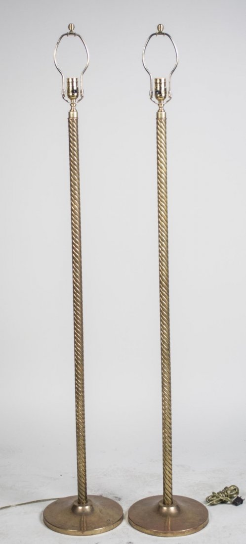Pair of Brass Floor Lamps: Single light lamps, twisted column on circular base. Height 58 inches. Notice to bidders: Condition reports and additional photographs are provided by request as a courtesy to our clients, as such any
