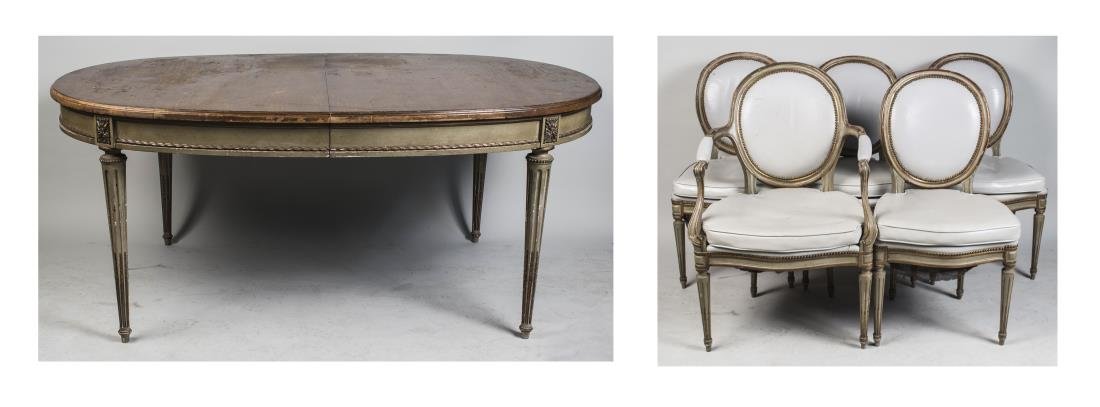 Louis XVI Style Dining Room Suite: Oval top wood table on tapered, fluted, painted legs, together with an armchair and four side chairs. Chair height 38 inches, width 25 inches, depth 25 inches. Table height 30 inches, width 72 inches,