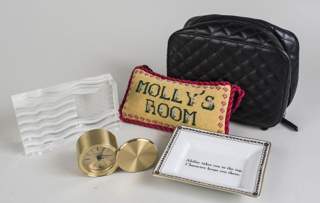 Miscellaneous Group of Table Decorations: Brass Tiffany & Co. desk clock, pillow, paperweight, dish, etc. Various sizes. Notice to bidders: Condition reports and additional photographs are provided by request as a courtesy to our clients, as