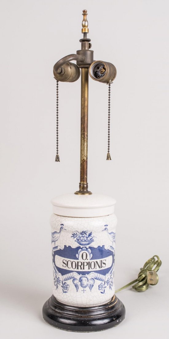 Scorpionis Table Lamp: Pottery two light lamp in the shape of an apothecary jar. Base, height 8 1/2 inches. Notice to bidders: Condition reports and additional photographs are provided by request as a courtesy to our client