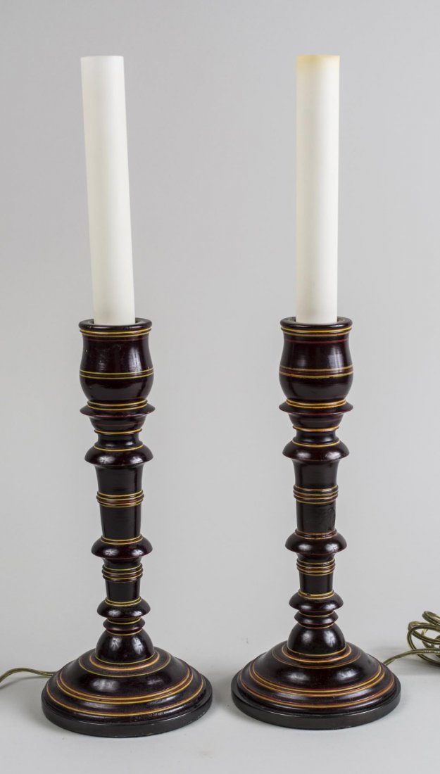 Pair of Candlestick Lamps: Single light lamps having black painted bases with gilt trim. Overall height 20 inches. Notice to bidders: Condition reports and additional photographs are provided by request as a courtesy to our cli