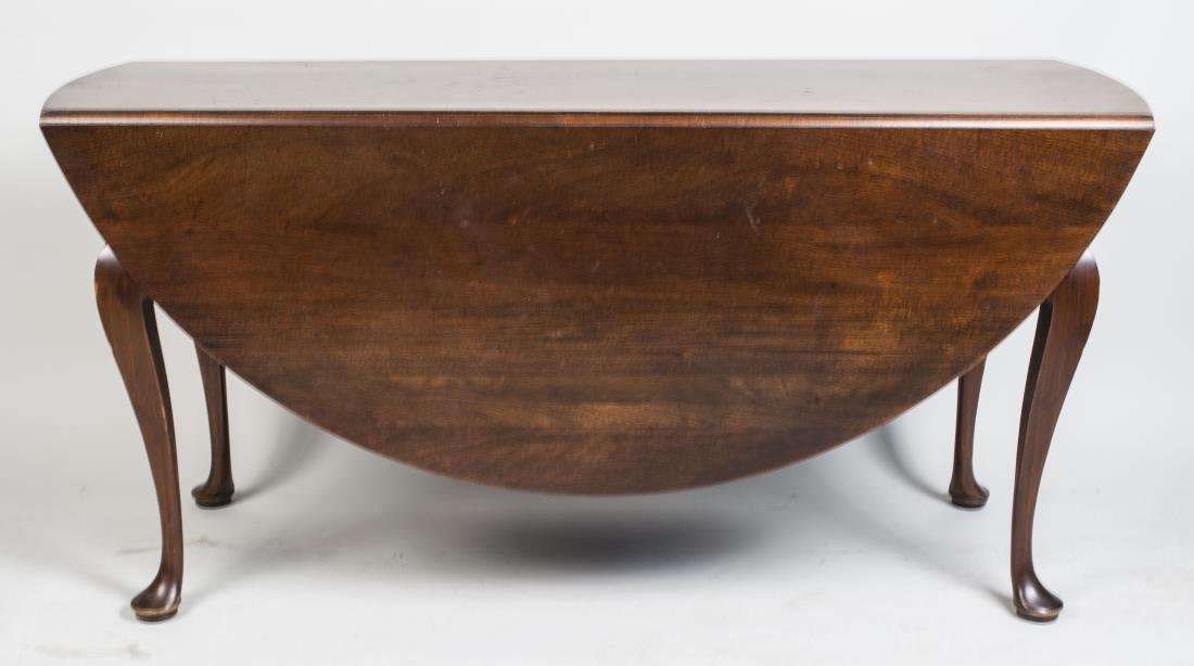 Queen Anne Style Mahogany Drop Leaf Dining Table: Rectangular top with rounded ends, two D shaped drop leaves, on cabriole legs ending in pad feet. Height 30 inches, width 61 inches, depth 20 inches. Notice to bidders: Condition reports and additiona