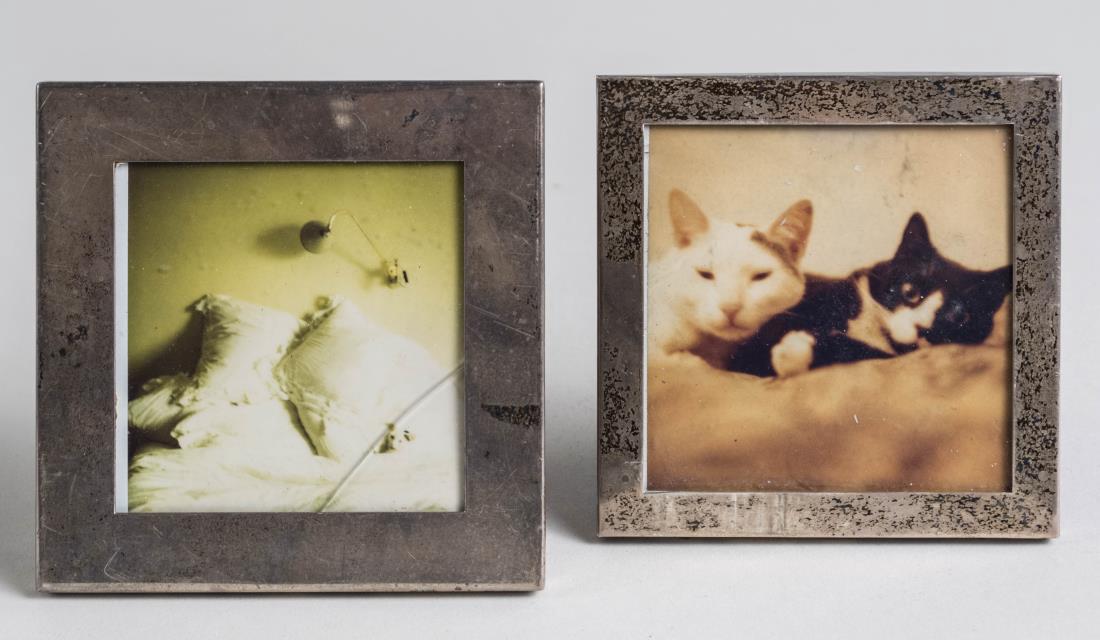 A Tiffany & an Augello Bros. Silver Picture Frames: Two square sterling silver picture frames. Both hold 3 x 3 photo. Notice to bidders: Condition reports and additional photographs are provided by request as a courtesy to our clients, as such any cond