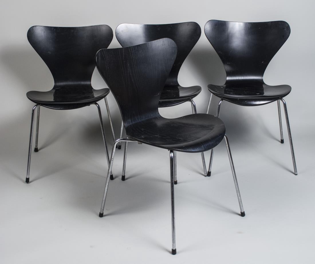 Set of Four Arne Jacobsen Series 7â„¢ Chairs: Manufactured by Fritz Hansen, black with molded plywood back and seat on tubular chrome legs. Height 31 inches, width 18 inches, depth 17 inches. Notice to bidders: Condition reports and additional ph