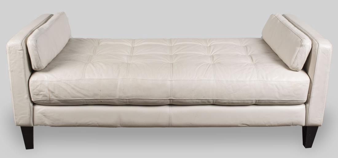 Leather Daybed: Slightly off white button tufted upholstery, on square tapered legs. Height 27 inches, width 70 inches, depth 33 inches. Notice to bidders: Condition reports and additional photographs are provided by