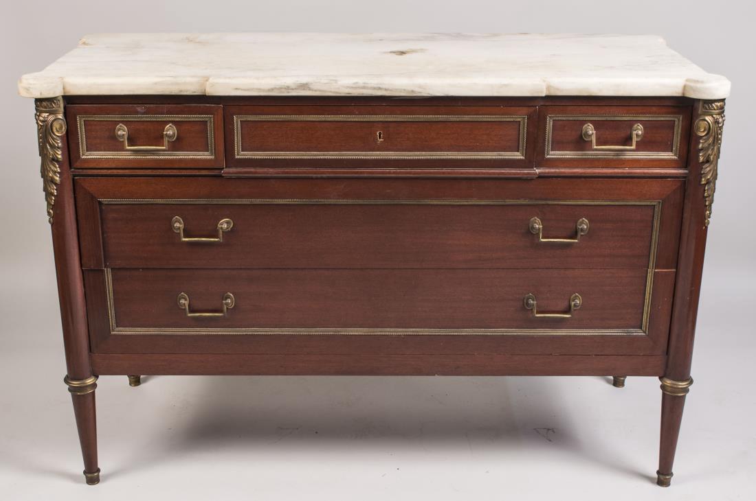 Louis XVI Style Marble Top Commode: Late 19th / Early 20th century, bronze mounted, with a rectangular white marble top with outset corners above a bank of three short drawers and two long drawers, on round tapered legs. Height 36 inche