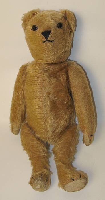 Caramel-colored Teddy bear: with moveable arms, legs, and head; with little hump on the back, button eyes, ca. 1890.