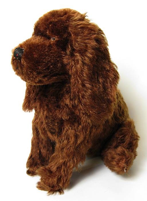 Vintage stuffed dog: 9" tall, in sitting position, with glass eyes