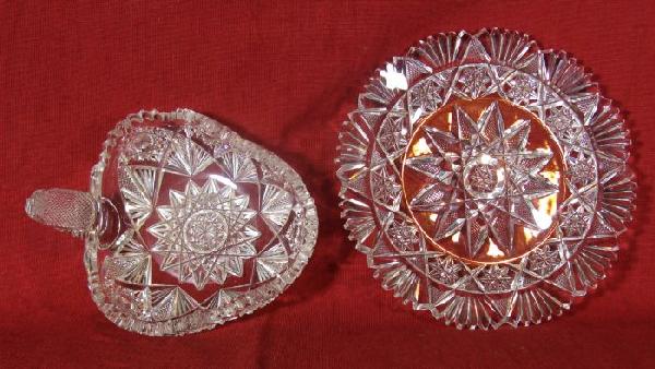 Two cut glass pieces: including: a dish 7 1/4" dia., (several very small chips on the serrated edge); and pickle dish 6 3/4" long, with thumb grip (small chips on serrated edge).