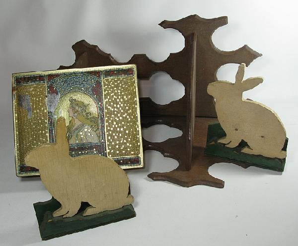 Three assorted pieces: including: two painted wooden folk art rabbit doorstops (one broken ear); a mosaic design tin chocolate box (good condition); a wooden gothic style corner bric-a-brac shelf 20" high (good condition)l