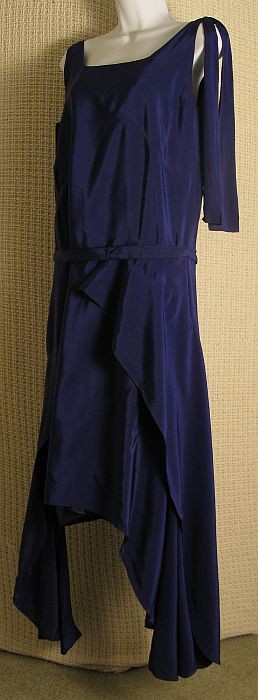 1920's Royal Blue Silk Dress: Art Deco silk dress. Belted/sleeveless w asymmetrical handkerchief panels at hemline, shoulder swag, serged edges, matching slip. Cond: VG no rips/tears w v faint discoloration underarms.